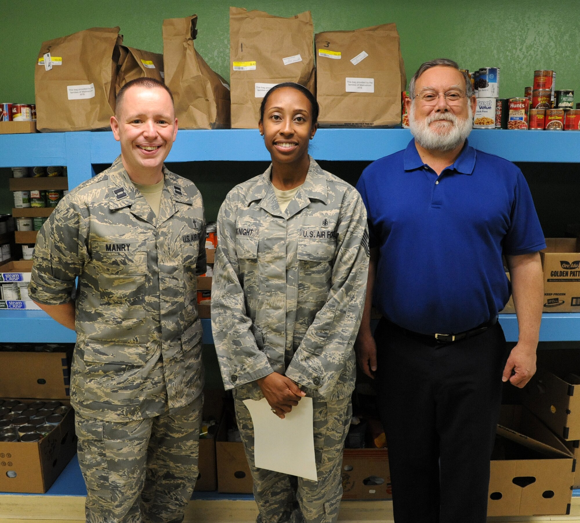 Malmstrom Air Force Base’s points of contact for the 2014 Feds Feed Families campaign are Chaplain (Capt.) Keith Manry, 341st Missile Wing chaplain (left), Tech. Sgt. Tanisha McKnight, 341st Medical Operations Squadron dental clinic NCO in charge (center), and Jerry Contreras, Malmstrom Air Force Base Commissary store director (right). The base has already collected 4,900 pounds of food and other non-perishable items in their first year as part of the campaign.(U.S. Air Force photo/Airman 1st Class Joshua Smoot) 