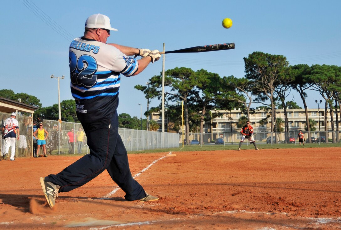 101st Air Operations Group player Joshua Wiggs slams what became an over-the-fence home run during the Tyndall Intramural Softball Championship game against the 325th Maintenance Squadron team August 5. Later in the game, when MXS had bases loaded with one out, Wiggs was instrumental in orchestrating a double play, eliminating any further threat of the opponent scoring. (Photo by A1C Sergio Gamboa) 