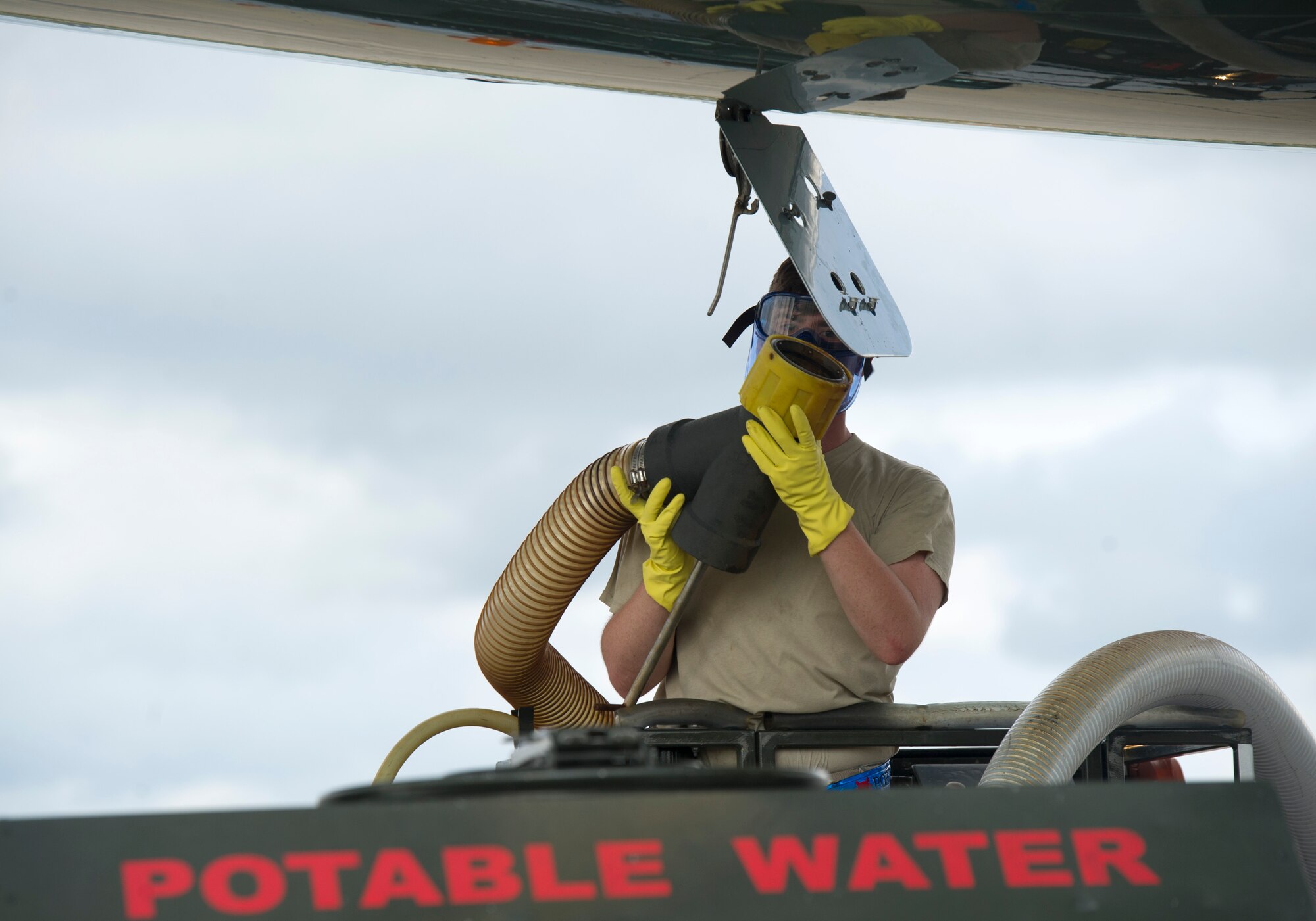 Senior Airman Troy Henshaw, 89th Aerial Port Squadron aircraft services technician, empties a distinguished visitor’s aircraft lavatory on the flight line at Joint Base Andrews, Md., Aug. 3, 2014. Airmen assigned to the 89th APS will service 27 dignitaries’ aircraft between July 30 and August 10 as distinguished visitors arrive and depart for the U.S. Africa Leader Summit in Washington D.C. (U.S. Air Force photo/ Senior Airman Nesha Humes)