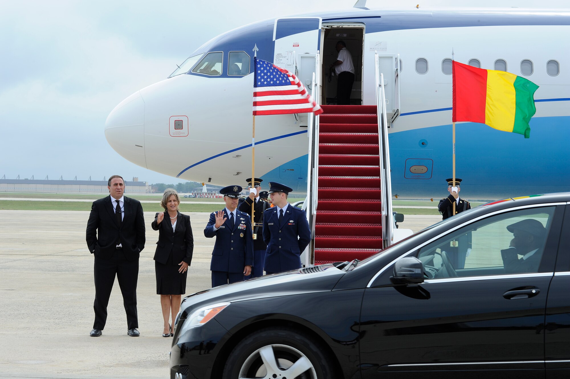 Members of Joint Base Andrews and the Department of State see off the motorcade carrying the Republic of Guinea President, Alpha Conde, on the JBA flightline Aug. 2, 2014. President Conde was making his way to the US - Africa Leaders Summit in Washington D.C. JBA members worked collaboratively with the Department of State, Secret Service and FAA, among others, to ensure the safe arrival and departure of distinguished visitors traveling to and from the summit via the airfield. (U.S. Air Force photo/Senior Airman Kat Lynn Justen)