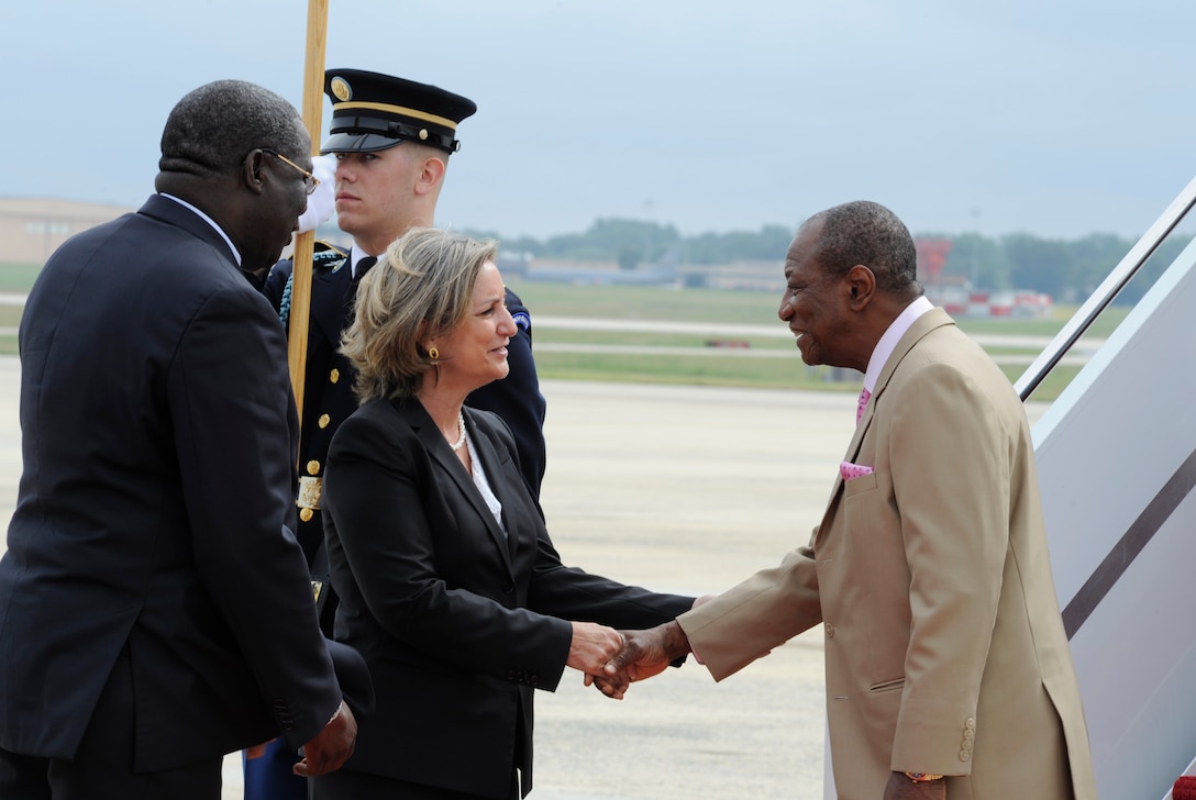 Gladys Boluda, Department of State protocol, greets Alpha Conde, President of the Republic of Guinea, on the Joint Base Andrews flightline Aug. 2, 2014. President Conde arrived to attend the US - Africa Leaders Summit in Washington D.C. JBA members worked collaboratively with the Department of State, Secret Service and FAA, among others, to ensure the safe arrival and departure of distinguished visitors traveling to and from the summit via the airfield. (U.S. Air Force photo/Senior Airman Kat Lynn Justen)