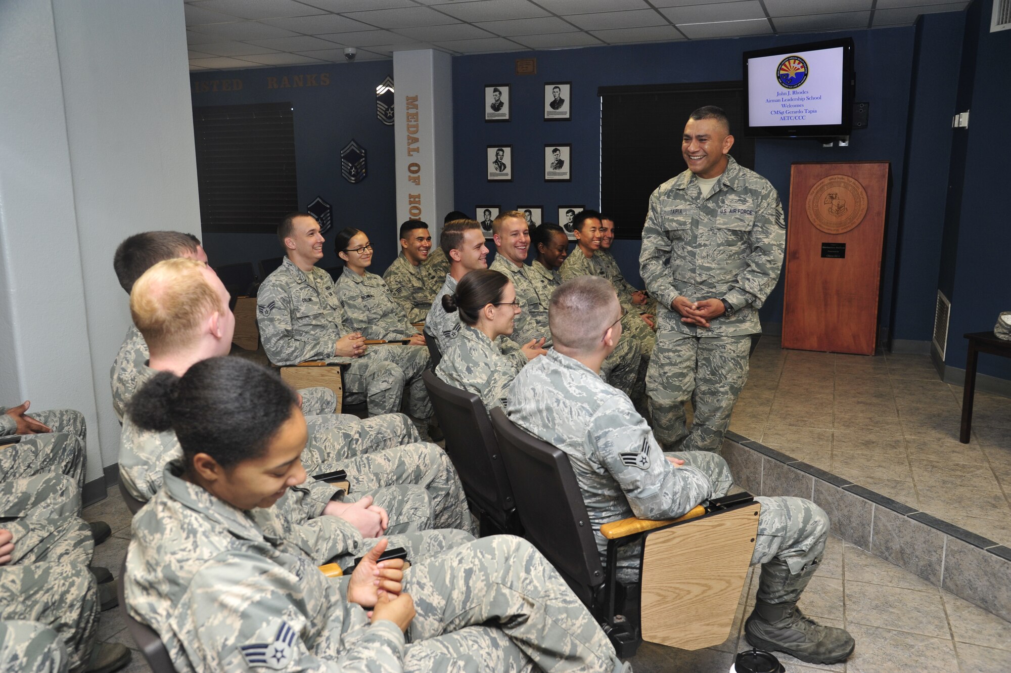 Command Chief Master Sgt. Gerardo Tapia, Air Education and Training Command, speaks to Airman Leadership School students Aug. 1 in the ALS building at Luke Air Force Base. During his visit, Tapia also met with First Term Airman Center students, first sergeants and NCOs, and attended briefings. (U.S. Air Force photo/Senior Airman Grace Lee)