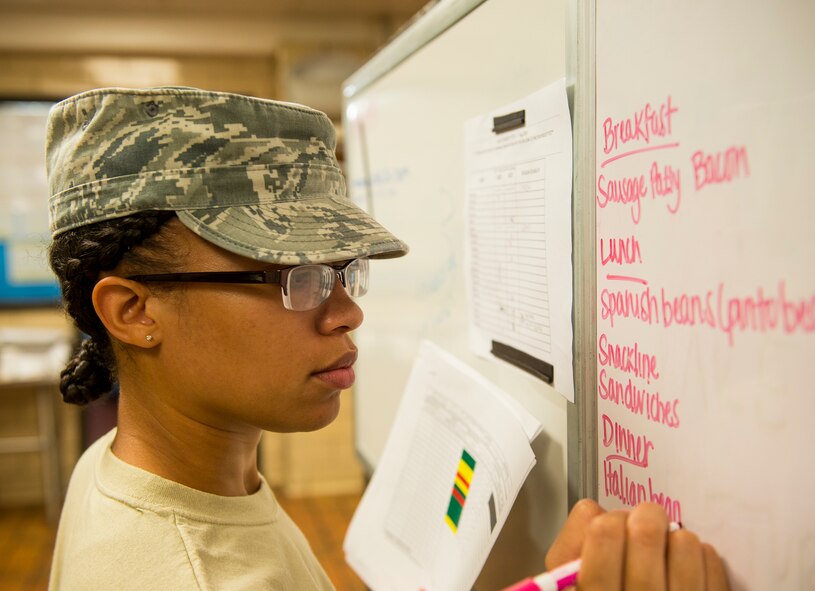 U.S. Air Force Senior Airman Erika Deaver, 23d Force Support Squadron services journeyman, writes the daily menu at the Georgia Pines Dining Facility, Moody Air Force Base, Ga.,  Aug. 7, 2014. Deaver used a production log to determine what foods to prep for the next day’s breakfast, lunch and dinner. (U.S. Air Force photo by Airman 1st Class Ceaira Tinsley/Released)