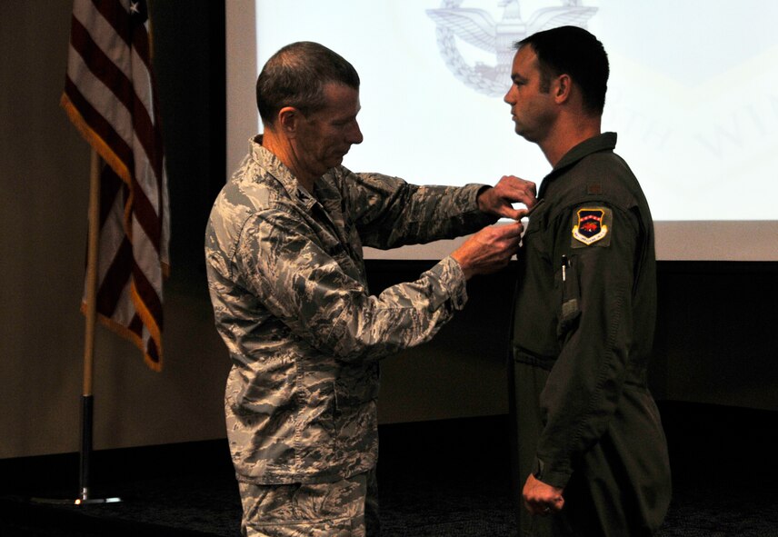 Col. Mark W. Anderson, 188th Wing commander, left, presents the Air Force Combat Action Medal to Maj. Jeremiah S. Gentry, pilot with the 188th Wing. Gentry was involved in combat while flying his A-10C Thunderbolt II “Warthog” over the skies of Bagram Airfield, Afghanistan in 2012. (U.S. Air National Guard photo by Staff Sgt. John Suleski/released)