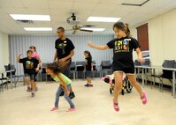 Exceptional Family Member Program children dance during Joint Base San Antonio 2014 Military & Family Readiness Arts and Dance Camp at JBSA-Randolph, July 9, 2014. The a three-day summer camp helps guide children in learning dance moves, playing music and participating in arts and crafts activities. (U.S. Air Force photo by Melissa Peterson)