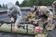 Senior Airman Kevin Dombey, a reserve pararescueman with the 304th Rescue Squadron, Portland Air National Guard Base, Ore., works alongside an Army National Guard medical provider to care for a simulated patient during Operation Pathfinder Minuteman Aug. 5, 2014 at Camp Rilea, Ore. Operation Pathfinder Minuteman was a joint disaster response exercise involving Air Force reservists, Air and Army National Guardsmen, and local, state federal civilian medical personnel. (U.S. Air Force photo/2nd Lt. Anna-Marie Wyant)