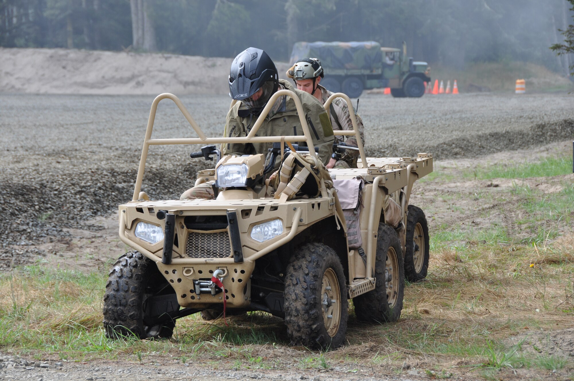 Reserve pararescuemen with the 304th Rescue Squadron, Portland Air National Guard Base, Ore., prepare to depart on an all-terrain vehicle during Operation Pathfinder Minuteman Aug. 5, 2014 at Camp Rilea, Ore. Operation Pathfinder Minuteman was a joint disaster response exercise involving Air Force reservists, Air and Army National Guardsmen, and local, state federal civilian medical personnel. (U.S. Air Force photo/2nd Lt. Anna-Marie Wyant)