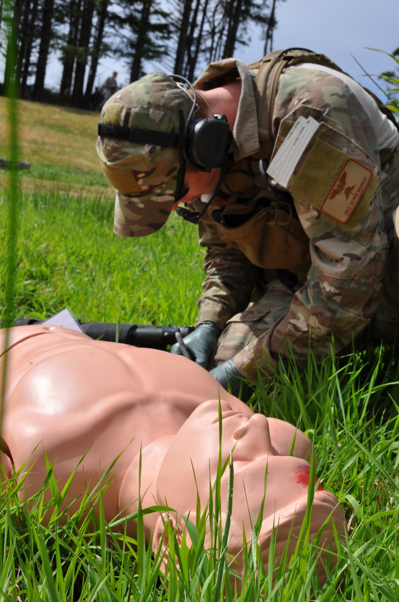 Senior Airman Quinn Murray, a reserve pararescueman with the 304th Rescue Squadron, Portland Air National Guard Base, Ore., simulates giving field medical care to a patient during Operation Pathfinder Minuteman Aug. 5, 2014 at Camp Rilea, Ore. Operation Pathfinder Minuteman was a joint disaster response exercise involving Air Force reservists, Air and Army National Guardsmen, and local, state federal civilian medical personnel. (U.S. Air Force photo/2nd Lt. Anna-Marie Wyant)