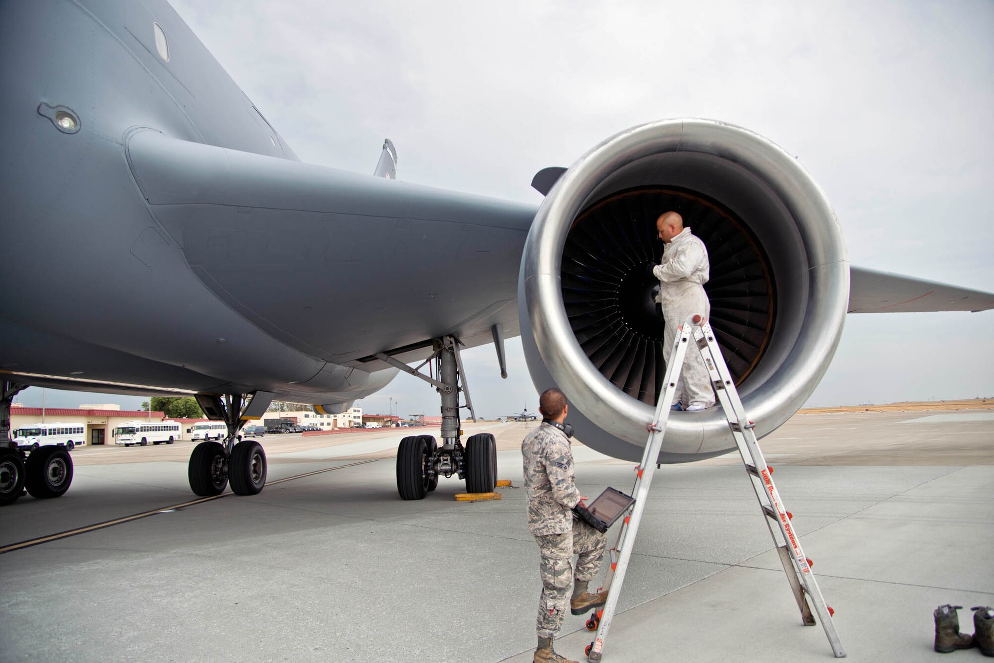 TRAVIS AIR FORCE BASE, Calif. -- Tech. Sgt. Johnny Martinez and Senior Airman David Delos Reyes, both from the 749th Aircraft Maintenance Squadron, thoroughly inspect the left wing engine of a KC-10 Extender after a flight Tuesday on the Travis Air Force Base flightline. (U.S. Air Force photo/Senior Airman Madelyn Brown)