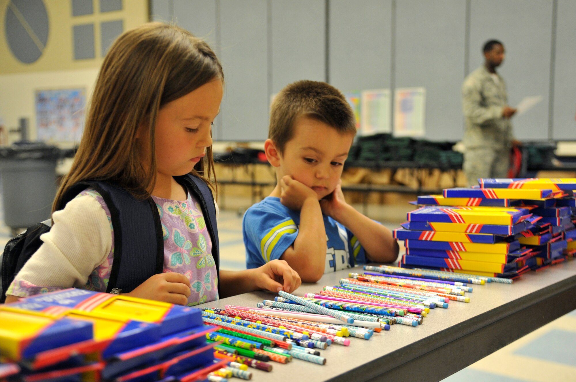 Isabelle Gonzalez and her brother Ethan decide which pencil to take for school during the Back-to-School Brigade in the Michael Anderson Elementary School gymnasium at Fairchild Air Force Base, Washington, Aug. 7, 2014. The Back-to-School Brigade is hosted by Operation Homefront. Operation Homefront is a non-profit organization that provides assistance for United States military troops and their families as well as wounded servicemen when they return home. (U.S. Air Force photo by Senior Airman Ryan Zeski/Released)