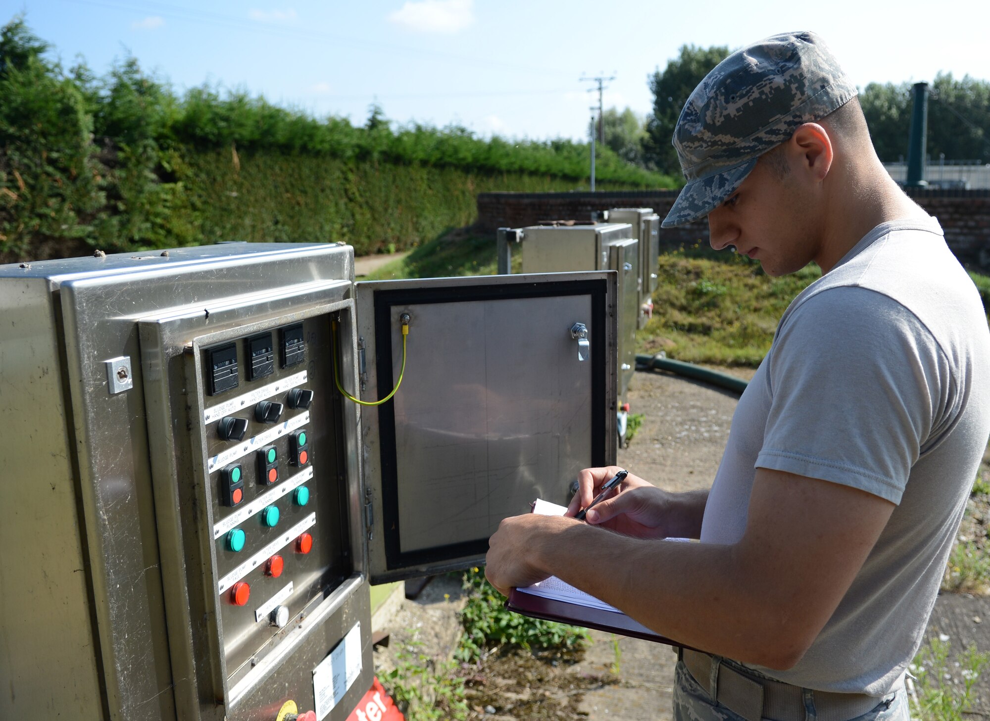 U.S. Air Force Airman 1st Class Jarrad Faulkner, 100th Civil Engineer Squadron water and fuels systems maintenance journeyman, checks the status of a water filtration system Aug. 7, 2014, on RAF Mildenhall, England. Each filter is checked daily to ensure it’s cleaning the water properly so it can be reintroduced into the environment safely. (U.S. Air Force photo/Airman 1st Class Dillon Johnston/Released)