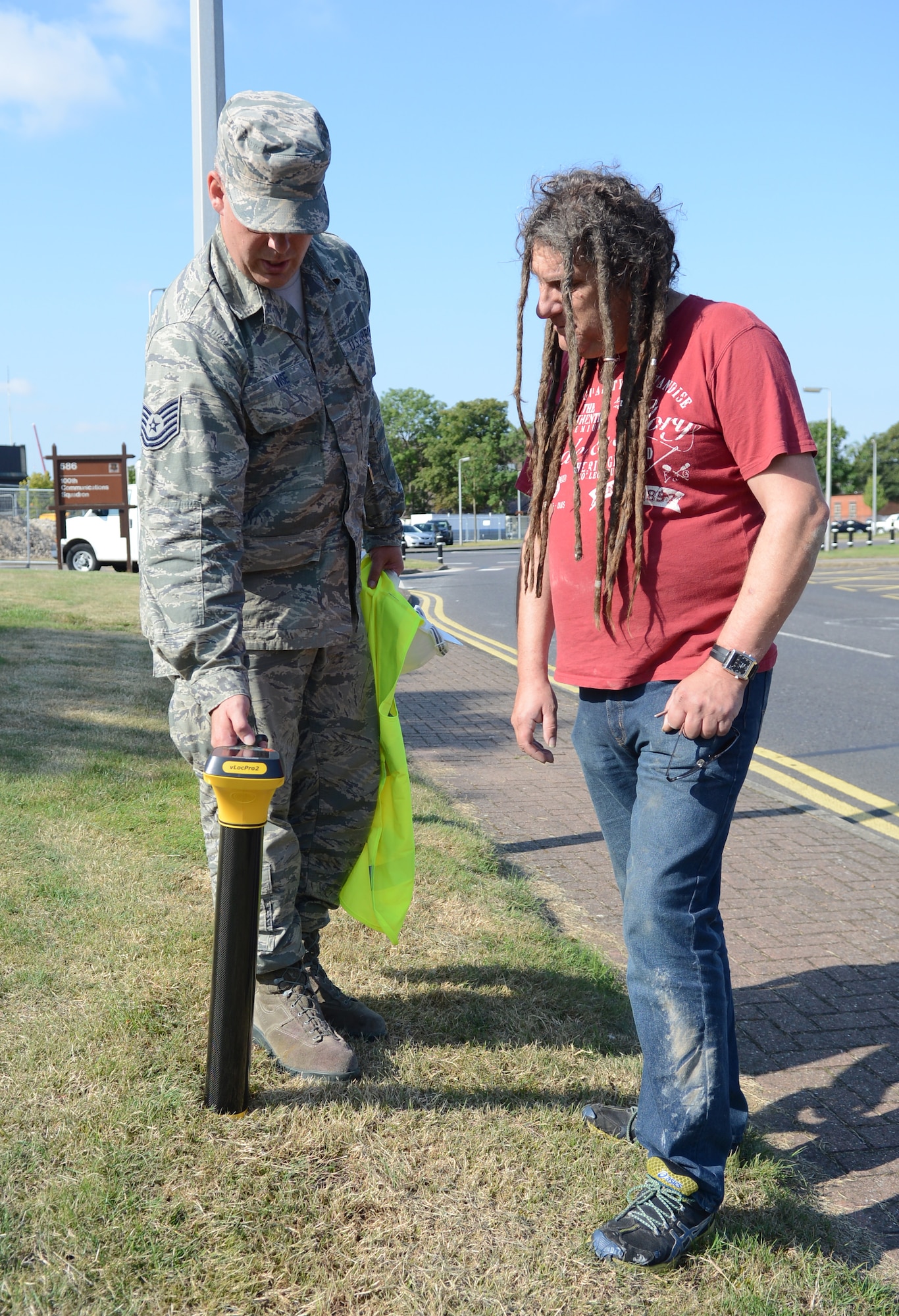 U.S. Air Force Tech. Sgt. Eric Wise, left, 100th Civil Engineer Squadron NCO in charge of water and fuels systems maintenance, and Paul Murfitt, 100th CES technical charge hand for liquid fuel systems from Red Lodge, Suffolk, use an electronic signal receiver to detect an unused pipe underground Aug. 7, 2014, on RAF Mildenhall, England. Once the pipe is located it is geo-tagged and removed if necessary. (U.S. Air Force photo/Airman 1st Class Dillon Johnston/Released)