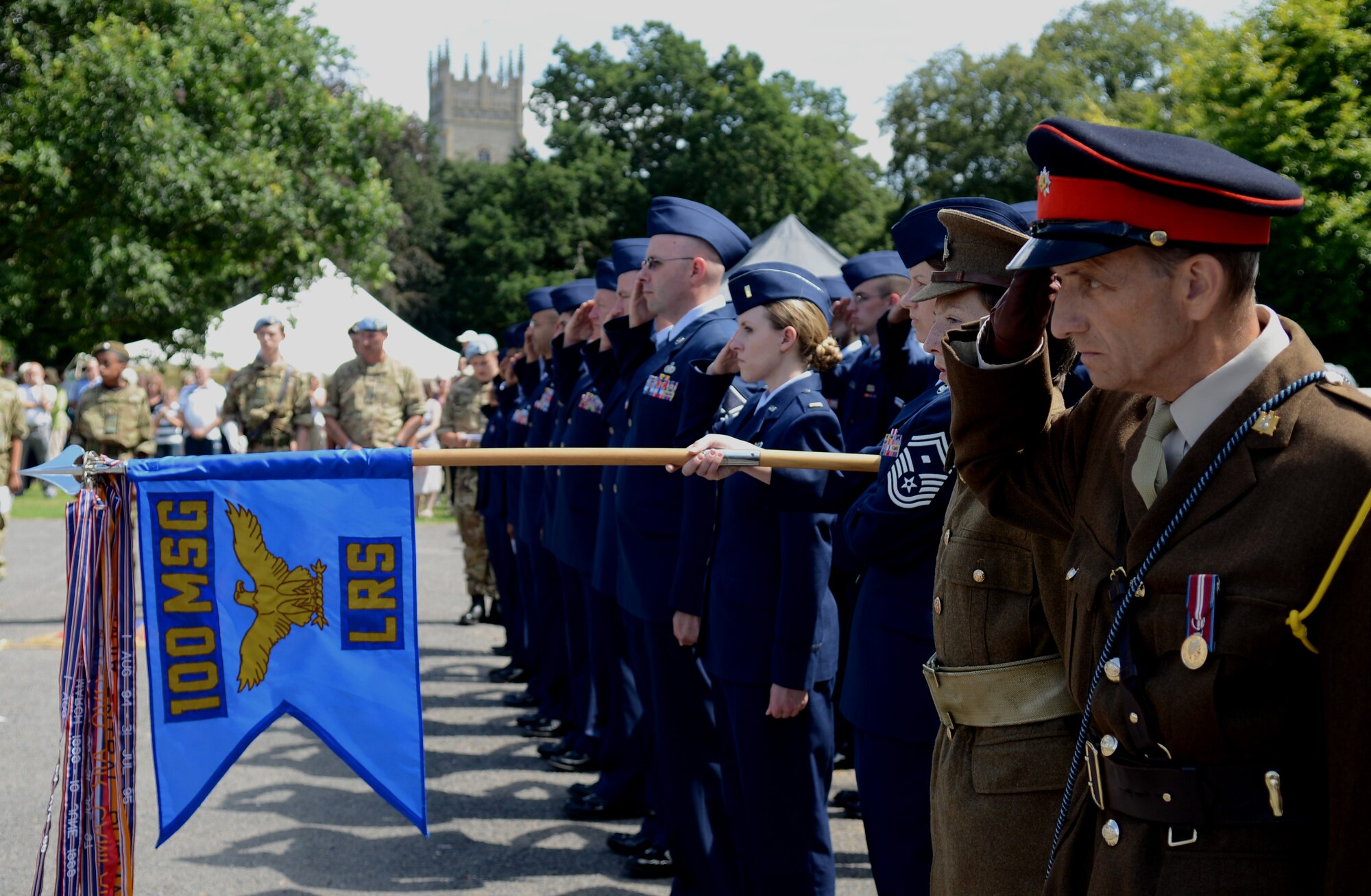 Members of the 100th Logistics Readiness Squadron salute beside their British counterparts during a World War I memorial service Aug. 3, 2014, in Soham, England. The event started at the war memorial in Soham and ended with a drum service and name reading of the fallen. (U.S. Air Force photo/Airman 1st Class Kyla Gifford/Released)