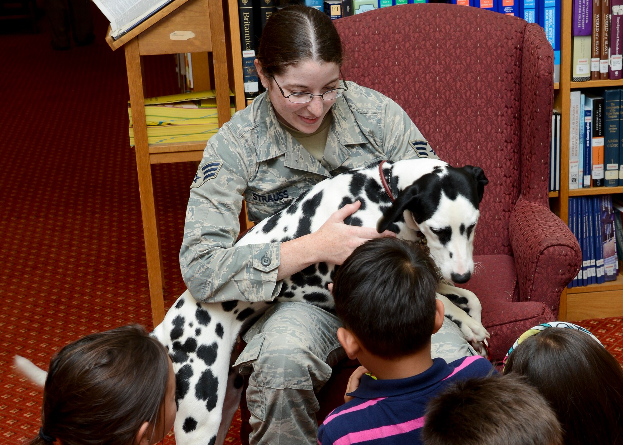 U.S. Air Force Senior Airman Nicole Strauss, 48th Contracting Squadron contract specialist from Philadelphia, speaks to children about the Pets Enriching Troops program Aug. 6, 2014, on RAF Mildenhall, England. PET is an organization which offers education and resources to benefit service members and their pets. (U.S. Air Force photo/Airman 1st Class Victoria H. Taylor/Released)