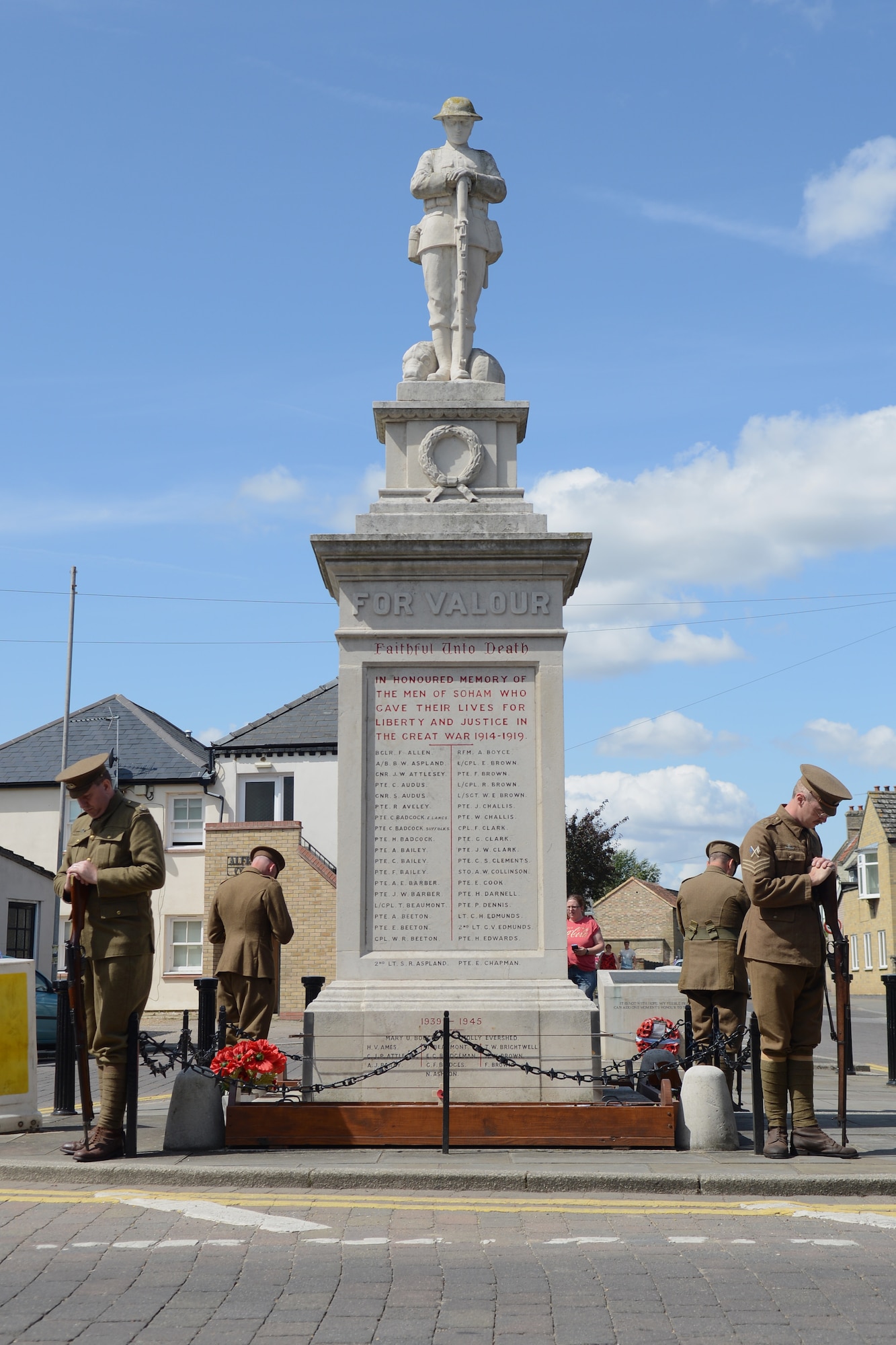 Volunteers dressed in World War I uniforms stand around a war memorial before a World War I memorial parade Aug. 3, 2014, in Soham, England. The event started at the memorial in Soham and ended with a drum service and name reading of the fallen. (U.S. Air Force photo/Airman 1st Class Kyla Gifford/Released)