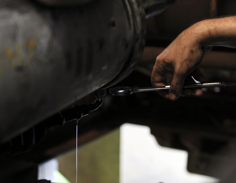 U.S. Air Force Senior Airman John Henry, 7th Logistics Readiness Squadron vehicle and vehicular maintenance journeyman, drains fluid from a hydraulic cylinder Aug. 5, 2014, at Dyess Air Force Base, Texas. Cracks were found in the bottom of the cylinder, which were causing it to leak and required a repair operation. (U.S. Air Force photo by Airman 1st Class Kedesha Pennant/Released)


