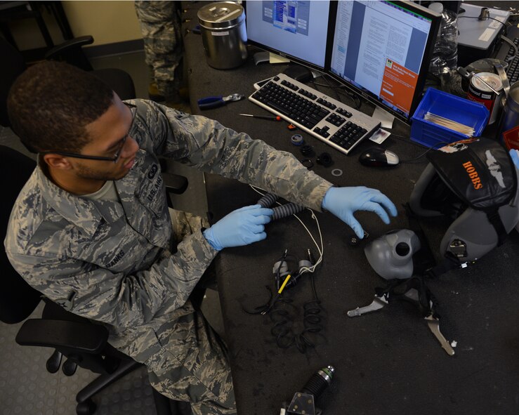 Airman Michael Banks, 2nd Operations Support Squadron Aircrew Flight Equipment helmet shop, inspects parts of a helmet on Barksdale Air Force Base, La., Aug. 4, 2014. The helmet is thoroughly cleaned to remove any dirt and debris that may build up and to prevent potential sickness for the wearer. (U.S. Air Force photo/Senior Airman Benjamin Gonsier)