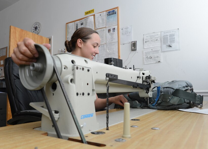 Airman 1st Class Heather Jackson, 2nd Operations Support Squadron Aircrew Flight Equipment parachute section, begins to sew a portion of a BA-21 parachute harness on Barksdale Air Force Base, La., Aug. 4, 2014. AFE Airmen are tasked with the responsibility of maintaining the equipment that may end up saving their lives one day. (U.S. Air Force photo/Senior Airman Benjamin Gonsier) 