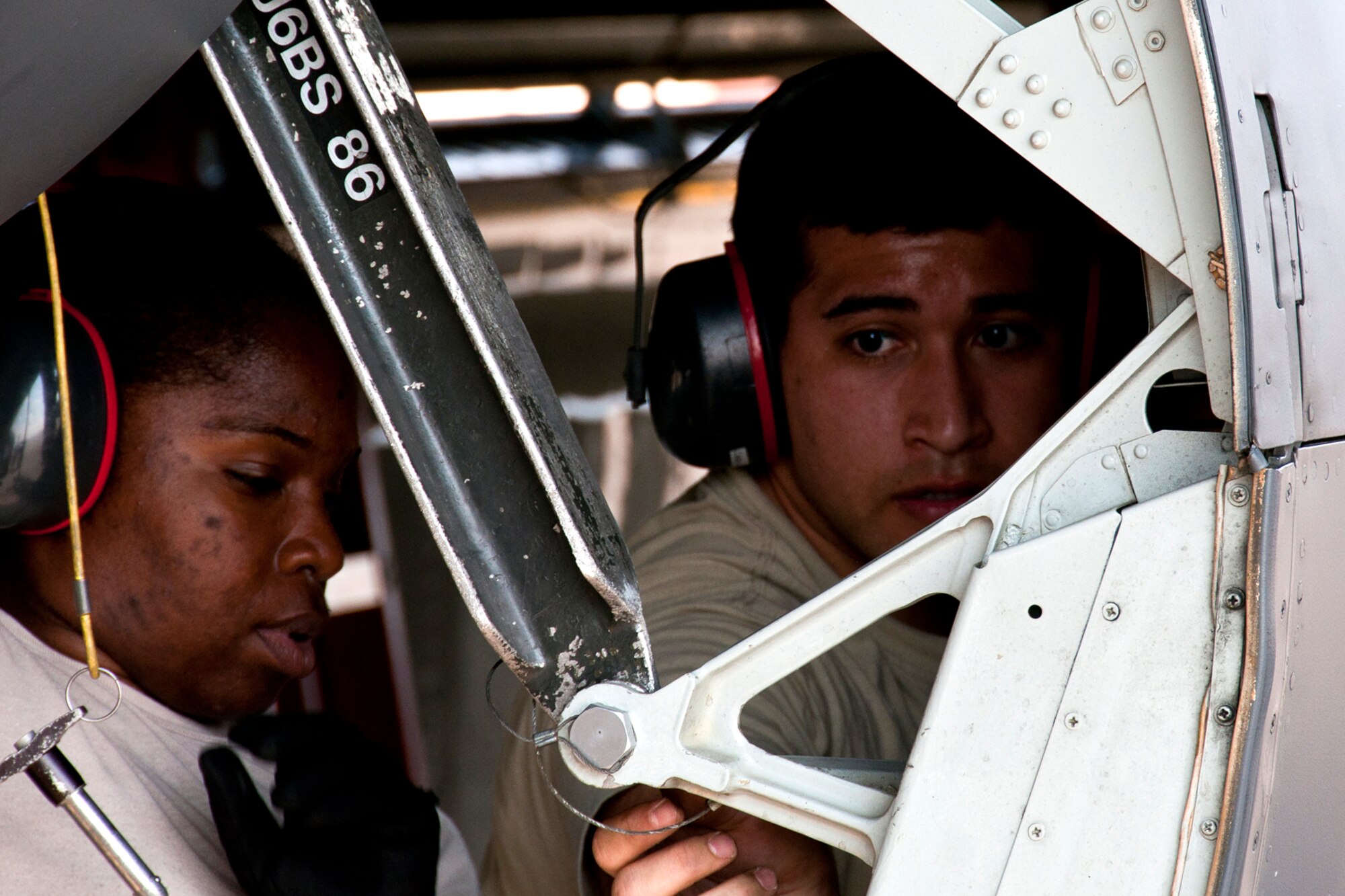 U.S. Air Force Tech. Sgt. Juan Camacho and Airman First Class Shayla Jackson install a brace on the bomb bay door of a 93rd Bomb Squadron B-52H Stratofortress as part of weapons load crew training on Aug. 3, 2014, Barksdale Air Force Base, La. Weapons load crews are required to participate in the training to acquire or maintain certification for loading live munitions on the aircraft. (U.S. Air Force photo by Tech. Sgt. Ted Daigle/Released)