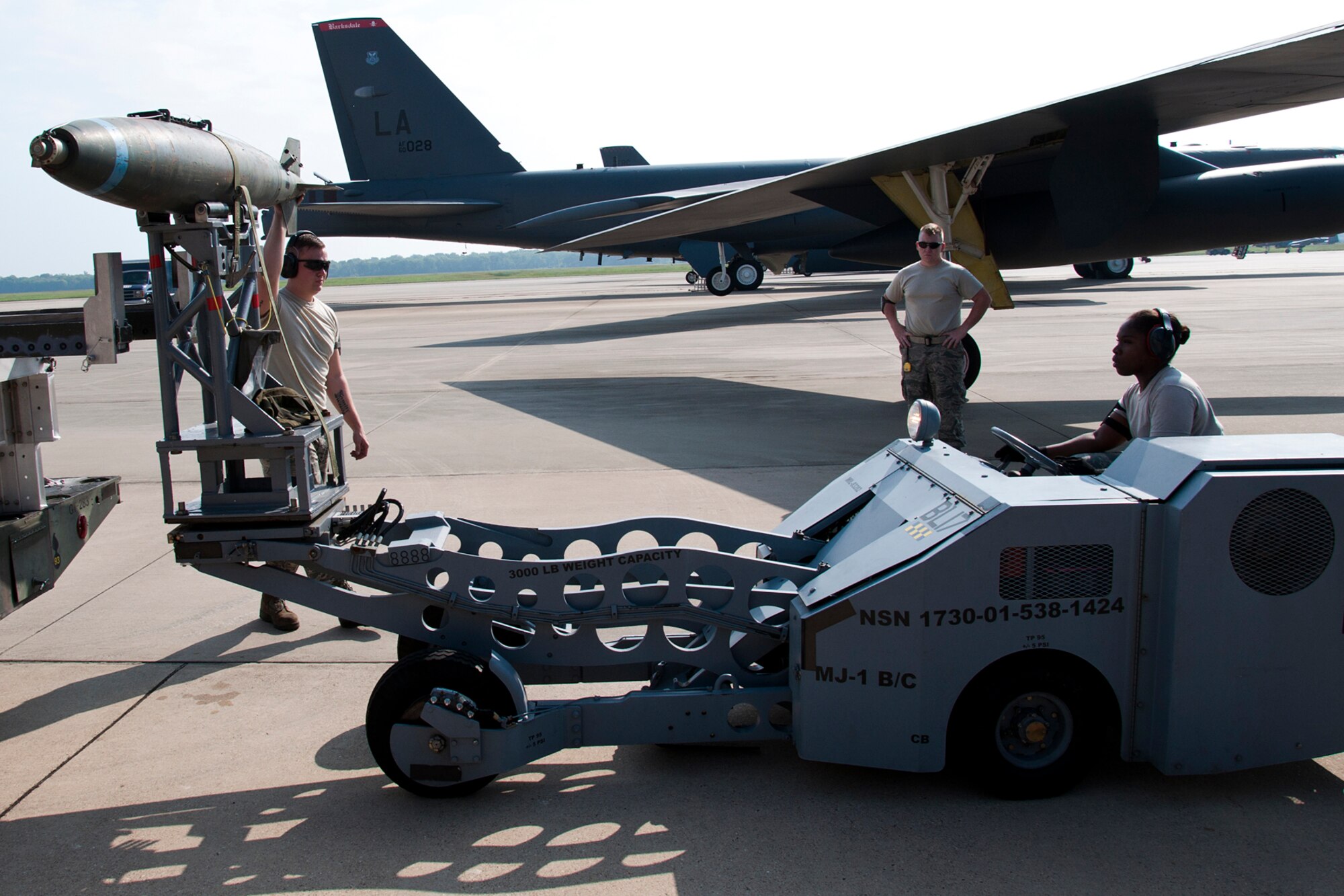 Weapons loaders assigned to the 307th Aircraft Maintenance Squadron prepare to load an inert 500 pound general purpose bomb on a B-52H Stratofortress during training on Aug. 3, 2014, Barksdale Air Force Base, La. Weapons load crews are required to participate in the training to acquire or maintain certification for loading live munitions on the aircraft. (U.S. Air Force photo by Tech. Sgt. Ted Daigle/Released)