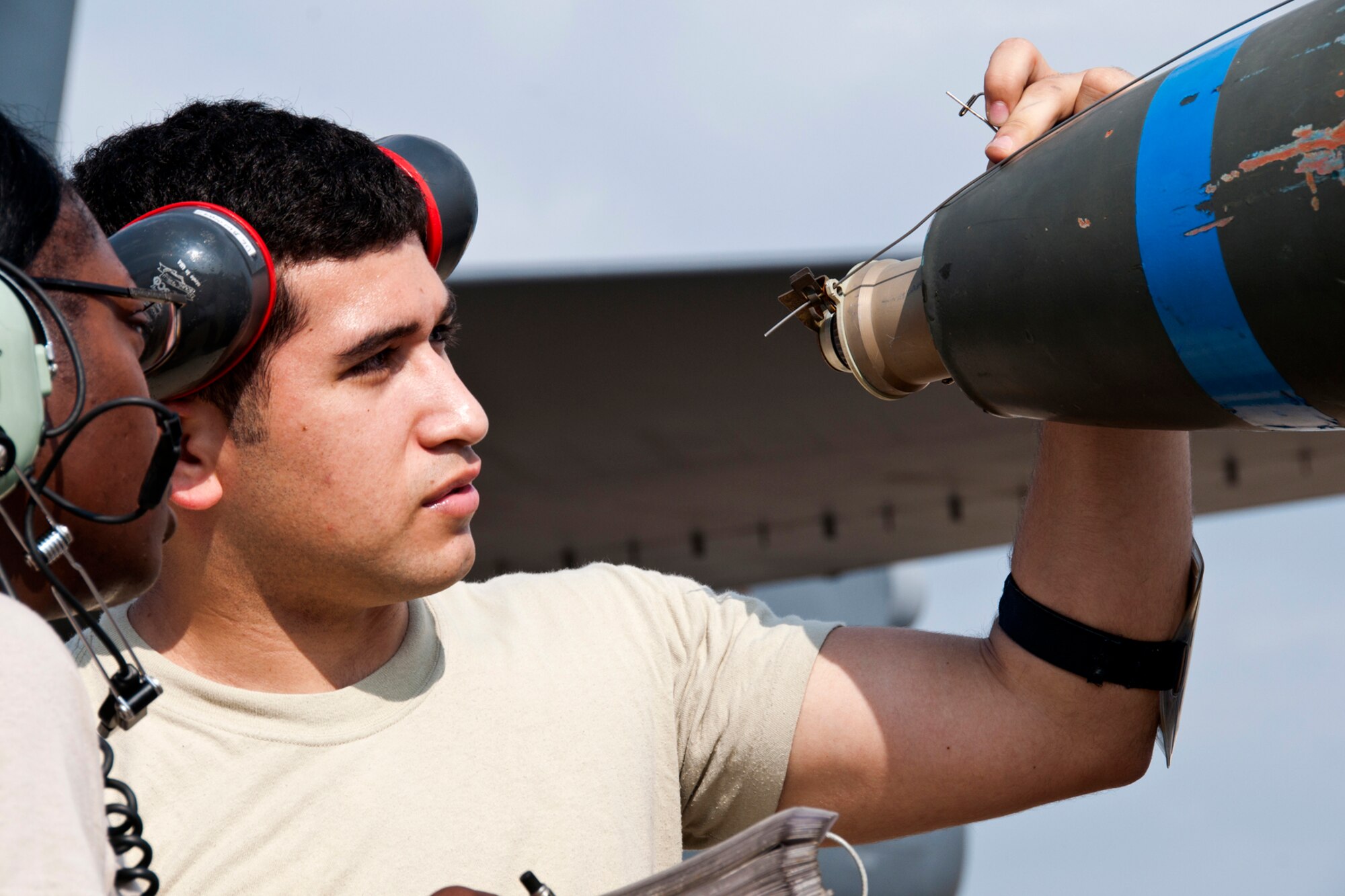 U.S. Air Force Tech. Sgts. Holly Guerra and Juan Camacho, inspect an M904 nose fuse on an inert 500 pound general purpose bomb during weapons load crew training on Aug. 3, 2014, Barksdale Air Force Base, La. Crews are required to participate in the training to acquire or maintain certification for loading live munitions on the aircraft. (U.S. Air Force photo by Tech. Sgt. Ted Daigle/Released)