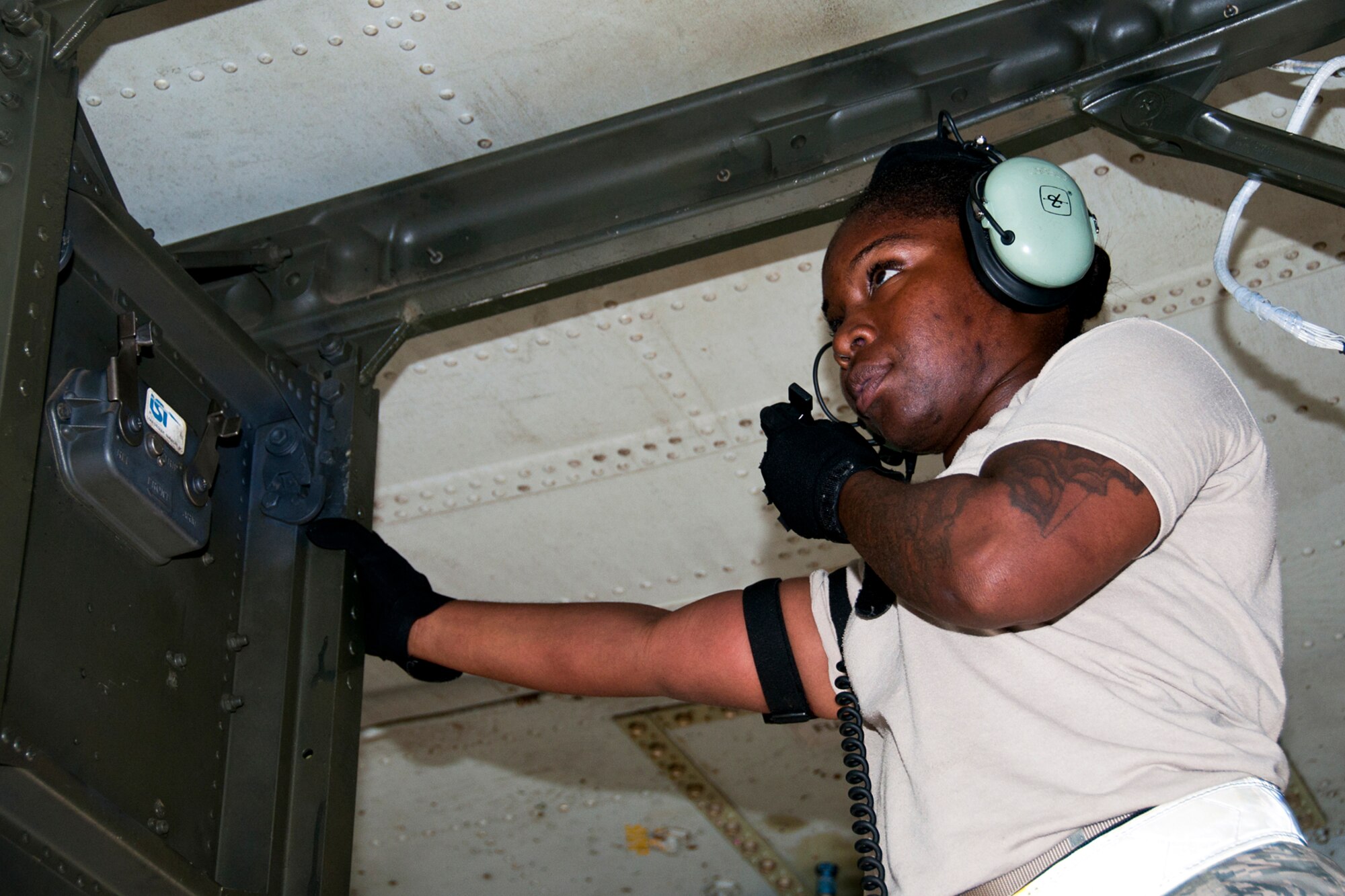U.S. Air Force Airman First Class Shayla Jackson, 307th Aircraft Maintenance Squadron weapons loader, performs a functional check on a Cluster Bomb Rack in the bomb bay of a B-52H Stratofortress during training on Aug. 3, 2014, Barksdale Air Force Base, La. Weapons load crews are required to participate in the training to acquire or maintain certification for loading live munitions on the aircraft. (U.S. Air Force photo by Tech. Sgt. Ted Daigle/Released)