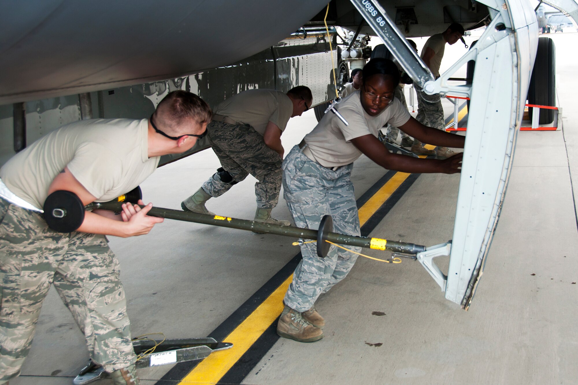 Weapons loaders assigned to the 307th Aircraft Maintenance Squadron prepare to raise a bomb bay door on a 93rd Bomb Squadron B-52H Stratofortress during load training on Aug. 3, 2014, Barksdale Air Force Base, La. Weapons load crews are required to participate in the training to acquire or maintain certification for loading live munitions on the aircraft. (U.S. Air Force photo by Tech. Sgt. Ted Daigle/Released)