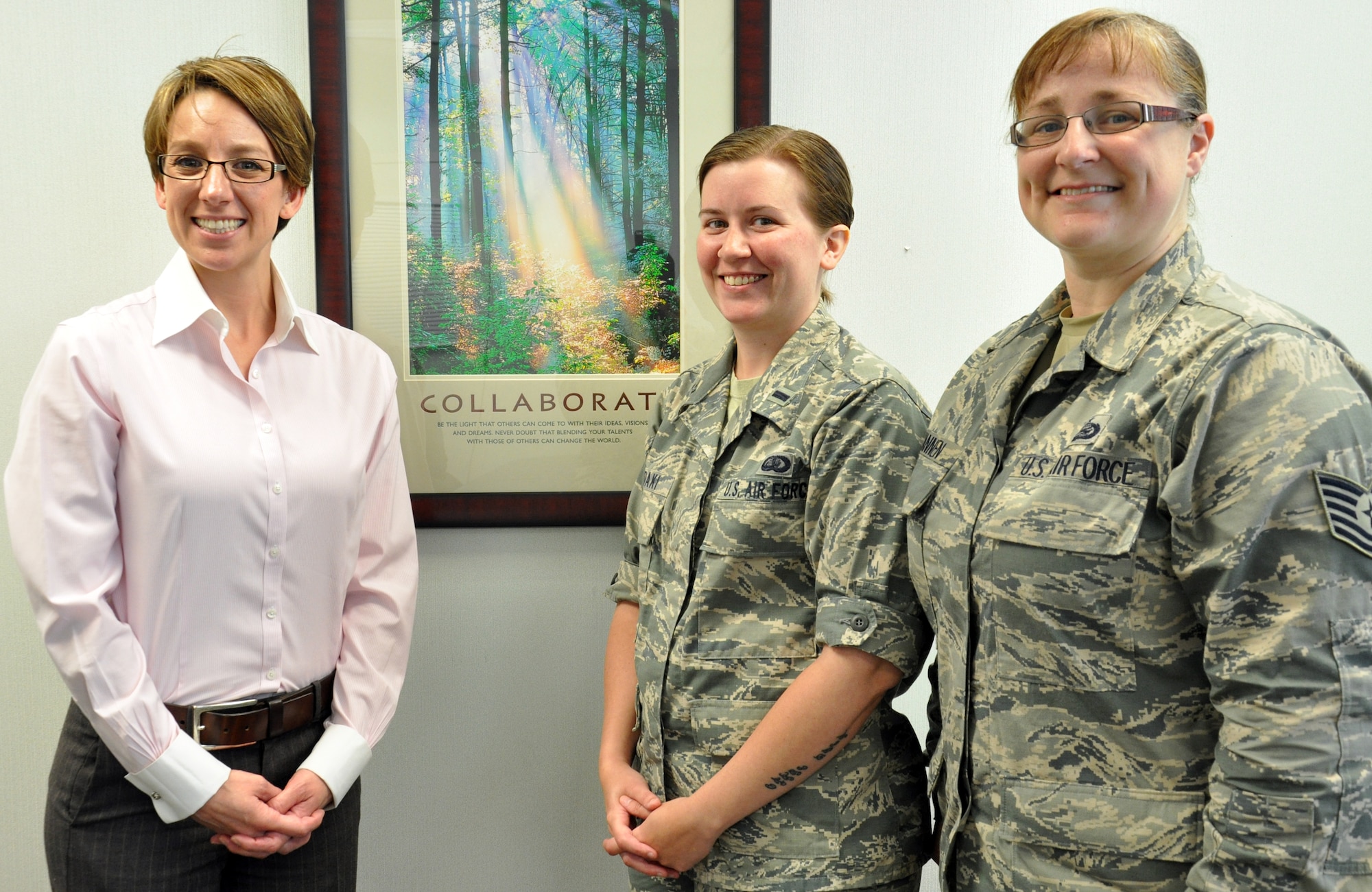 Heather Bradley (left), 1st Lt. Jillian Saridaki (center) and Tech. Sgt. Marisa Hannen (right), take a photo in the Equal Opportunity office July 6 at Travis Air Force Base. Not pictured is Tech. Sgt. Shantá Glover. Together, they are the 60th Air Mobility Wing EO office team. (U.S. Air Force photo/Staff Sgt. Christopher Carranza)