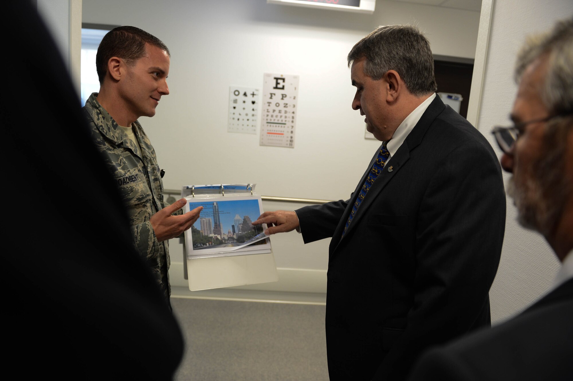 U.S. Air Force Staff Sgt. Brandon Broadbent, a 52nd Medical Operations Squadron ambulance services technician from Austin, Texas, talks with Brian Duffy, Veterans of Foreign Wars junior vice commander-in-chief, during a tour of the 52nd Medical Group at Spangdahlem Air Base, Germany, Aug. 7, 2014. Duffy visited the group to talk with Airmen about their role in serving the base. (U.S. Air Force photo by Airman 1st Class Kyle Gese/Released)