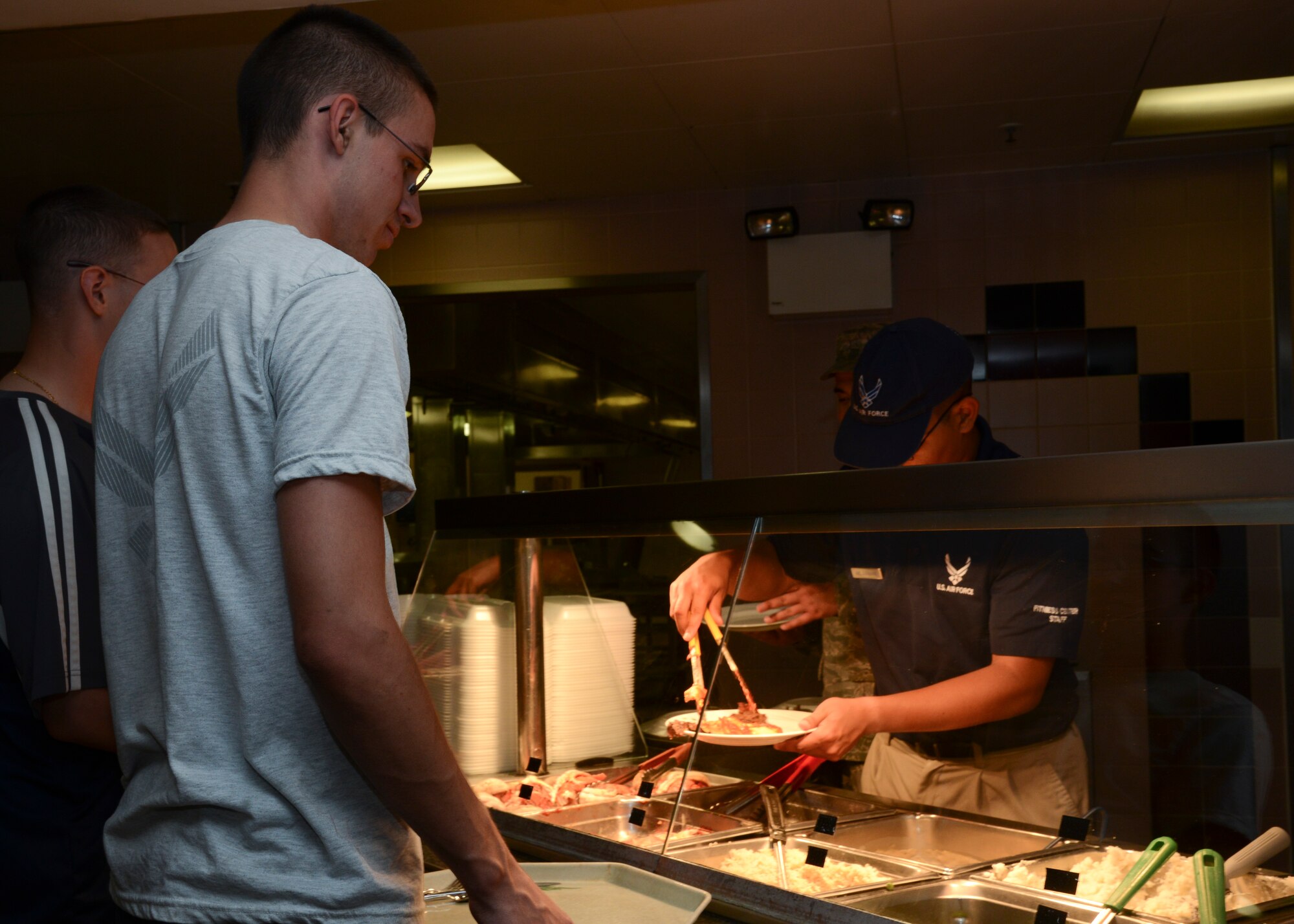 Team Mildenhall Airmen attend the Airman Appreciation Meal, Aug. 7, 2014 at the Gateway Dining Facility on RAF Mildenhall, England. The event was open to all who hold a valid Department of Defense ID Card and featured menu items such as steak and lobster tail. (U.S. Air Force photo/Airman 1st Class Victoria H. Taylor/Released)