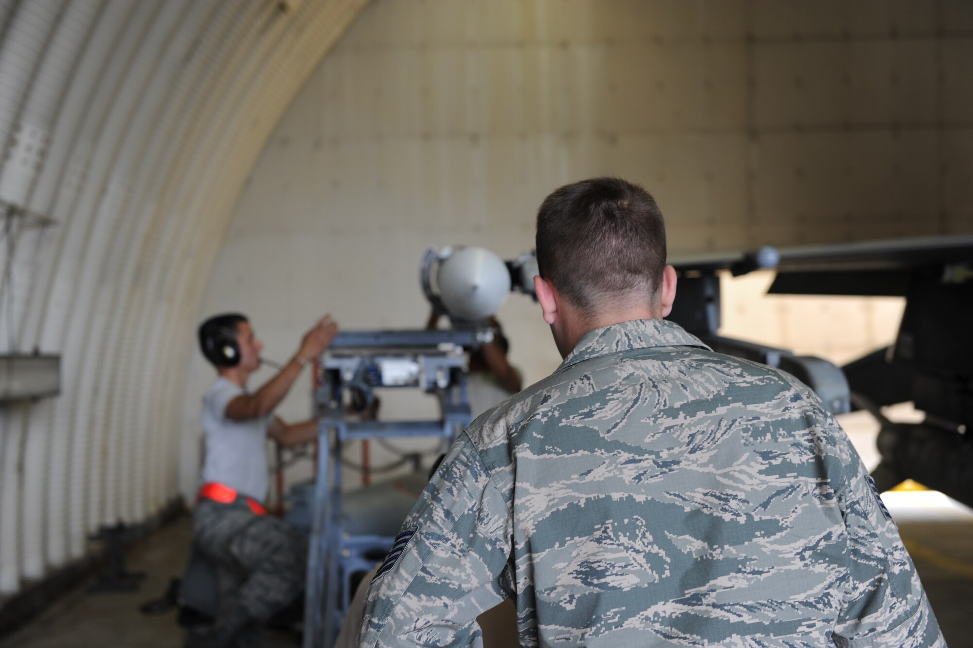 U.S. Air Force Tech. Sgt. Samuel Arpy, 52nd Maintenance Group lead standardization crew member, inspects a load crew load training munitions onto a U.S. Air Force F-16 Fighting Falcon fighter aircraft during a base exercise Aug. 6, 2014, at Spangdahlem Air Base, Germany. The crew inspected the 480th Aircraft Maintenance Unit during a base exercise. (U.S. Air Force photo by Airman 1st Class Dylan Nuckolls/Released)