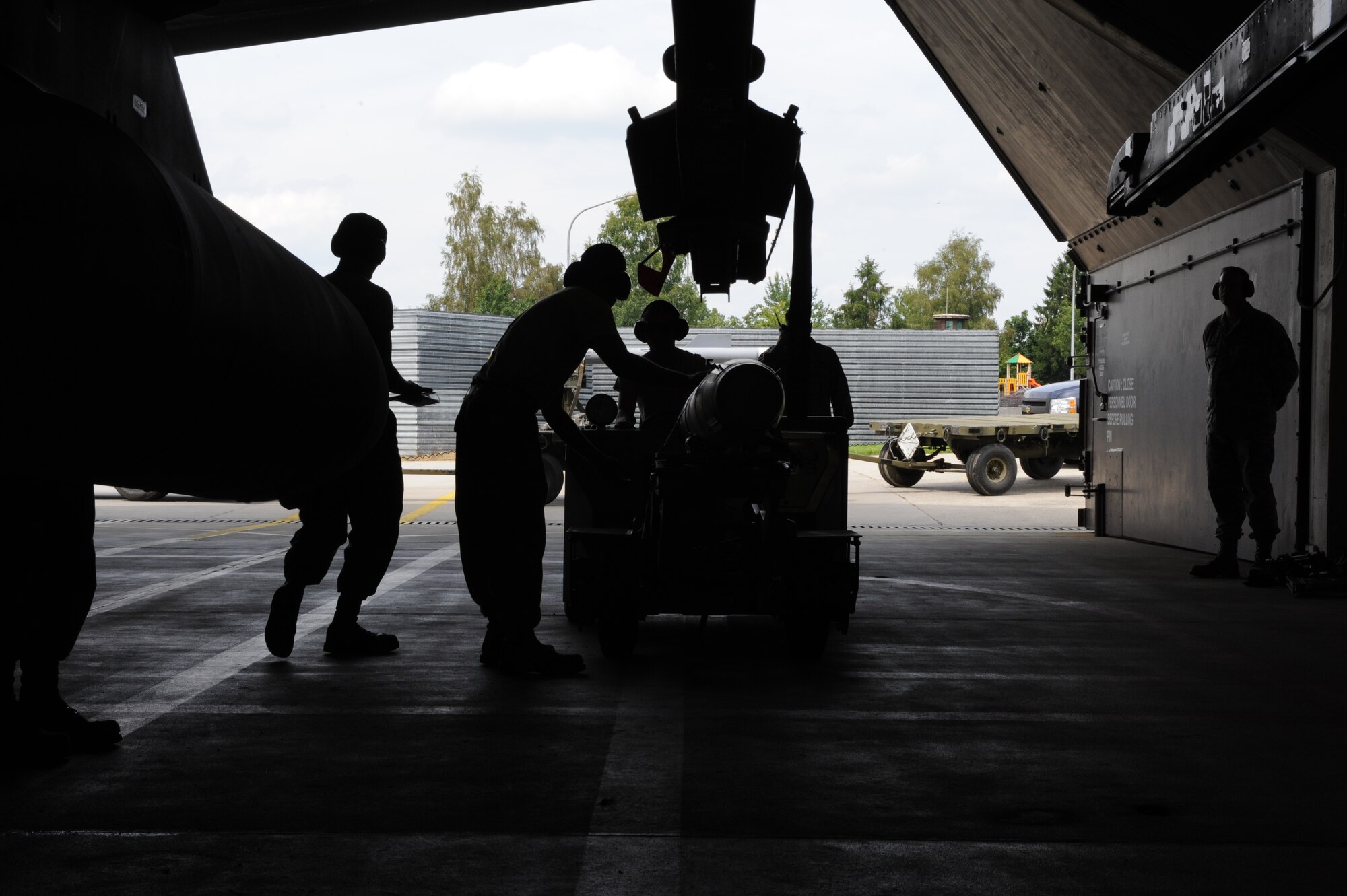 U.S. Air Force aircraft armament specialists from the 480th Aircraft Maintenance Unit load training munitions onto a U.S. Air Force F-16 Fighting Falcon fighter aircraft during a base exercise Aug. 6, 2014, at Spangdahlem Air Base, Germany. Load crews train to stay ready to be called upon by combatant commanders. (U.S. Air Force photo by Airman 1st Class Dylan Nuckolls/Released)