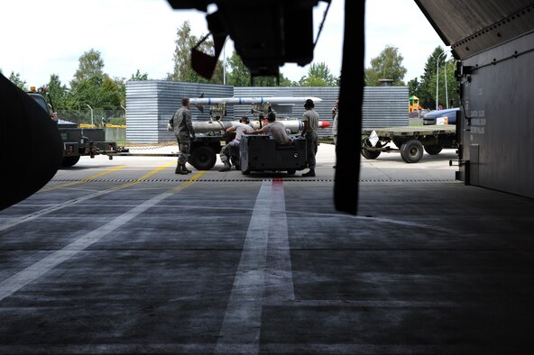 U.S. Air Force aircraft armament specialists from the 480th Aircraft Maintenance Unit prepare to load training munitions onto a U.S. Air Force F-16 Fighting Falcon fighter aircraft during a base exercise Aug. 6, 2014, at Spangdahlem Air Base, Germany. The exercise tested the 52nd Fighter Wing’s ability to maintain U.S. Air Forces in Europe and Air Forces Africa major command’s Forward-Ready-Now posture.  (U.S. Air Force photo by Airman 1st Class Dylan Nuckolls/Released)