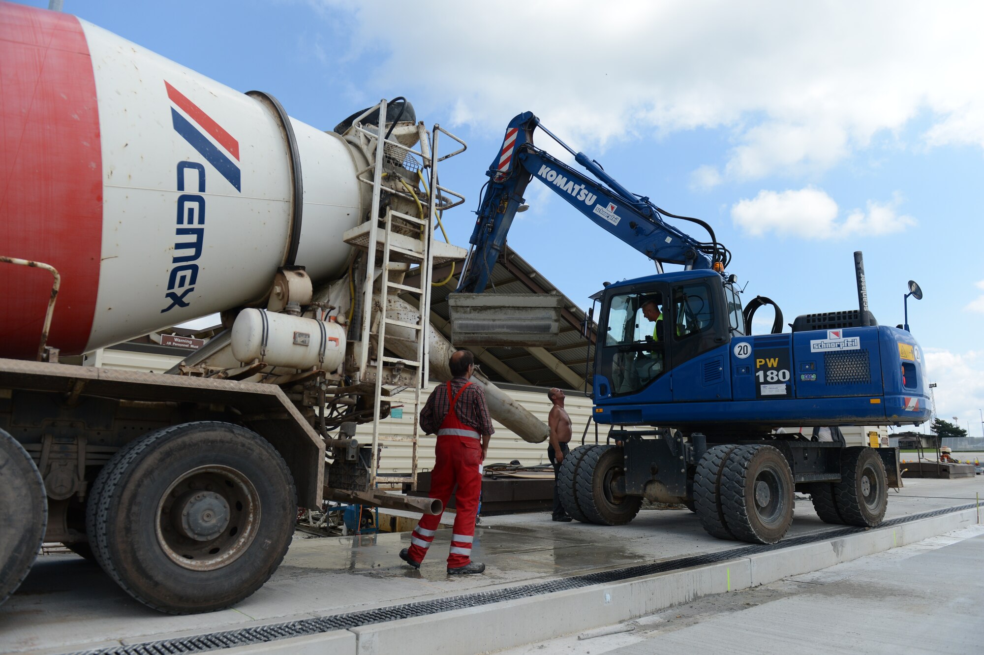 Local German contractors prepare to move concrete during construction on the flightline at Spangdahlem Air Base, Germany, Aug. 7, 2014. The construction began in April 2014 and the estimated completion date is September 2014. (U.S. Air Force photo by Senior Airman Gustavo Castillo/Released) 