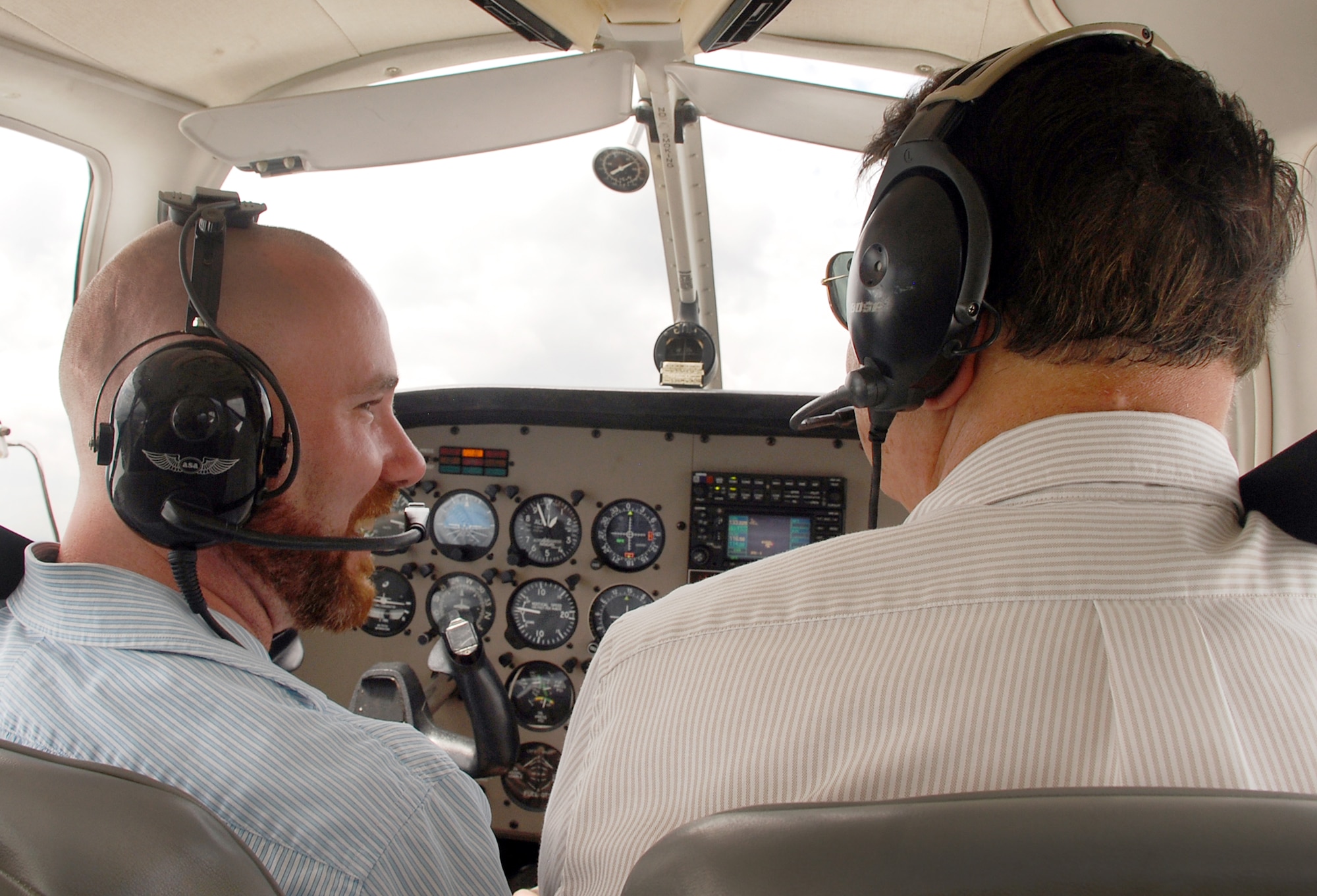 Brian Shreve, Rev-Up reporter (left), and Lewayne Davis, Robins Aero Club chief flight instructor, take one of the club's Piper Warrior III aircraft for a spin above Robins Air Force Base, Ga. The club was once limited to active duty personnel and Department of Defense civilians. On-base flying lessons are now available to all Middle Georgia residents following a recent partnership between the club and the local community. Base and local residents interested in signing up for flying lessons at the Robins Aero Club should call (478) 926-4867. (U.S. Air Force photo/Paul Wenzel)