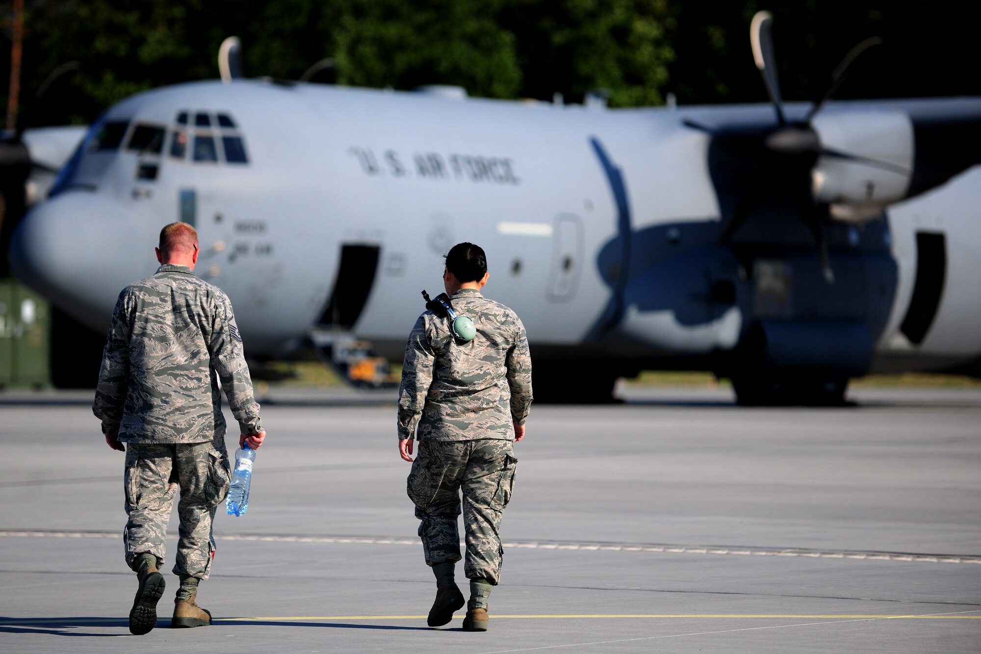 U.S. Air Force Master Sgt. Jeremy Leuch, 86th Aircraft Maintenance Squadron production superintendent, left, and 2nd Lt. Su Johnson, 86th AMXS sortie support officer in charge, walk toward a C-130J Super Hercules, preparing for takeoff during a flying training deployment in support of Operation Atlantic Resolve, at Powidz Air Base, Poland, Aug. 7, 2014. Heralded as the United States’ continuing commitment to collective security of NATO allies, the operation allows America to host a broad range of training opportunities with Poland and the neighboring Baltic States. (U.S. Air Force photo by Staff Sgt. Jarad A. Denton/Released)