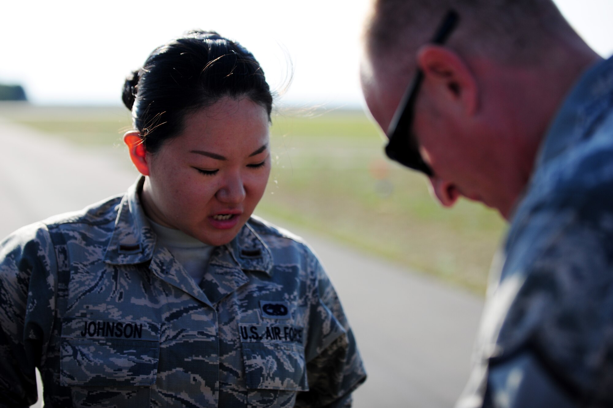 U.S. Air Force 2nd Lt. Su Johnson, 86th Aircraft Maintenance Squadron sortie support officer in charge, discusses maintenance operations with Master Sgt. Jeremy Leuch, 86th AMXS production superintendent, during a flying training deployment at Powidz Air Base, Poland, Aug. 7, 2014. This deployment, part of Operation Atlantic Resolve, focused on enhancing regional security and bolstering NATO partner capabilities. (U.S. Air Force photo by Staff Sgt. Jarad A. Denton/Released)