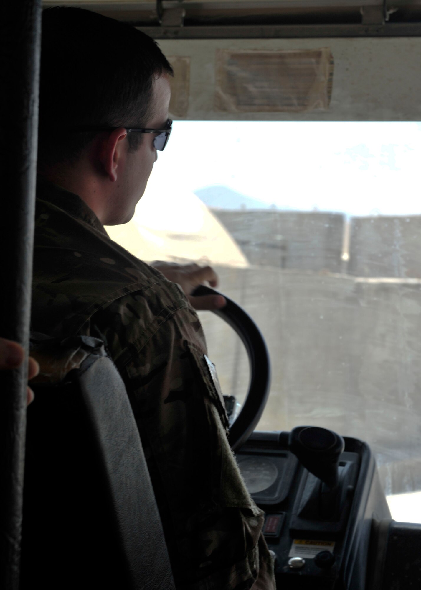 U.S. Air Force Staff Sgt. Jared Nieves 340th Expeditionary Air Refueling Squadron Detachment 1 vehicle operator, transports Airmen to work at Mazar-i-Sharif Airfield, July 24, 2014. Vehicle operators transport over 100 Airmen to and from work every day. Nieves is deployed from Eglin Air Force Base, Florida. (U.S. Air Force photo by Senior Airman Colin Cates) 