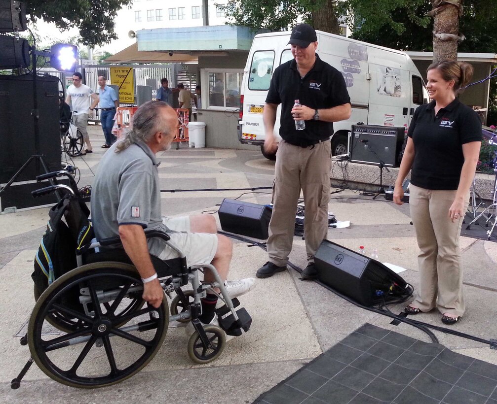 Recently, the USAFE Band "Afterburner" popular music ensemble performed in various locations around Tel Aviv, Israel in support of the US Embassy's Fourth of July celebration.  In this photo Technical Sergeant Jason Cale and Senior Airman Melissa Lackore interact with a patient at the Loewenstein Hospital Rehabilitation Center after a performance for the patients.