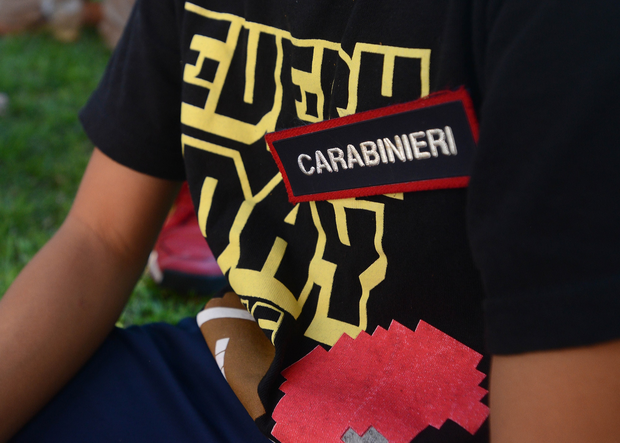 An Aviano Youth Program participant is given a Carabinieri patch, Aug. 6, 2014, after a tour of the Pordenone Carabinieri office. The AYP provides different camps every week throughout the summer that allow participants hands-on knowledge of things they are interested in. (U.S. Air Force photo/Airman 1st Class Deana Heitzman)