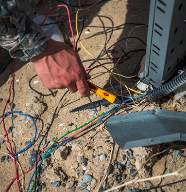 U.S. Air Force Master Sgt. Troy Hoffman, 386th Air Expeditionary Wing ground safety manager, tests exposed wiring to determine if it is a safety hazard July 31, 2014 at an undisclosed location in Southwest Asia. These tests are conducted to ensure Airmen are kept safe in their working environments. Hoffman is deployed from the 86th Airlift Wing, Ramstein Air Base, Germany. (U.S. Air Force photo by Staff Sgt. Jeremy Bowcock)