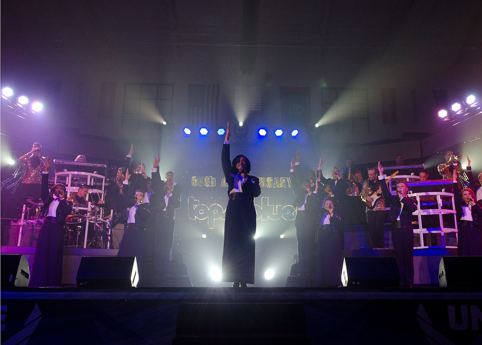 Tops in Blue performers end their show at the Coral Reef Fitness Center with a tribute to military members through song Aug. 6, 2014, on Andersen Air Force Base, Guam. Tops in Blue, now in its 61st year, tours Air Force installations around the world to perform for Airmen and their families. (U.S. Air Force photo by Senior Airman Katrina M. Brisbin)