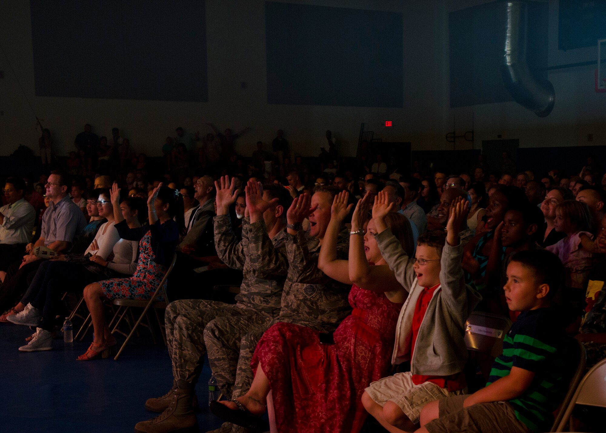 Audience members participate during a Tops in Blue performance at the Coral Reef Fitness Center Aug. 6, 2014, on Andersen Air Force Base, Guam. Tops in Blue, now in its 61st year, tours Air Force installations around the world to perform for Airmen and their families.  (U.S. Air Force photo by Senior Airman Katrina M. Brisbin)