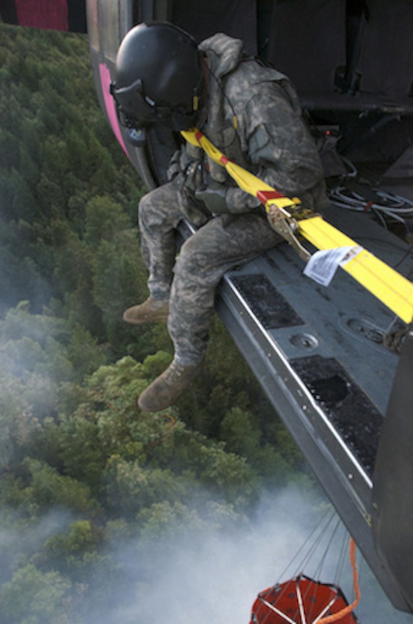 A UH-60 Black Hawk helicopter crew from the California Army National Guard drops 660 gallons of water on a Northern California fire, Aug. 4, 2014. U.S. Army photo by Sgt. 1st Class Benjamin Cossel