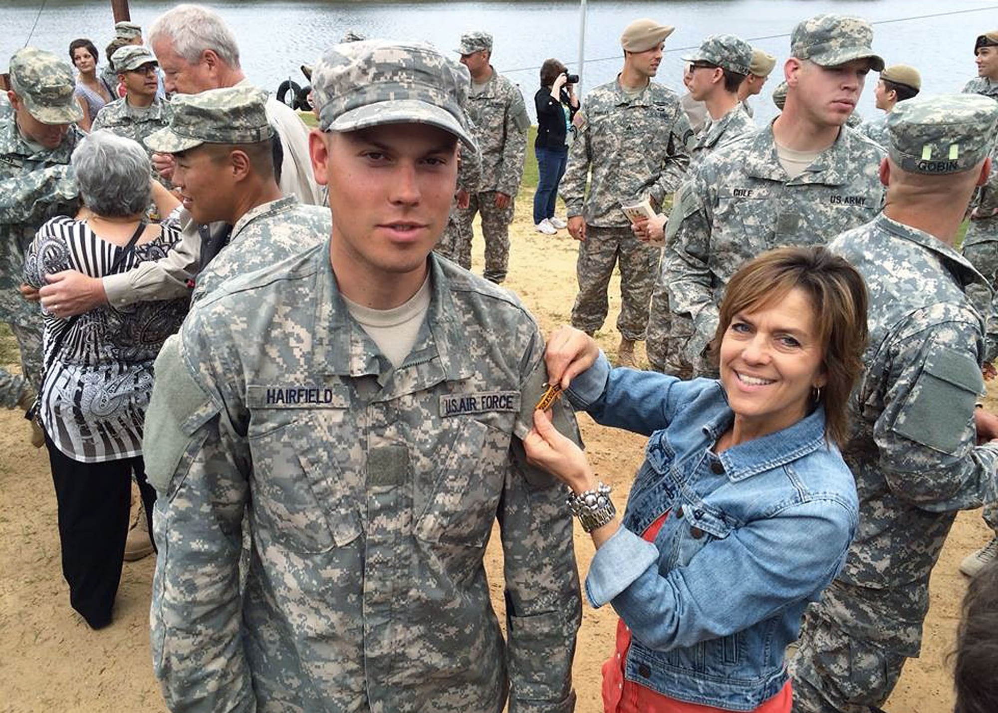 Senior Airman Austin Hairfield, 14th Air Support Operations Squadron tactical air control party member, poses as his mother, Melinda Harifield, pins his Ranger tab onto his uniform shortly after graduating from Army Ranger School. (Courtesy photo)