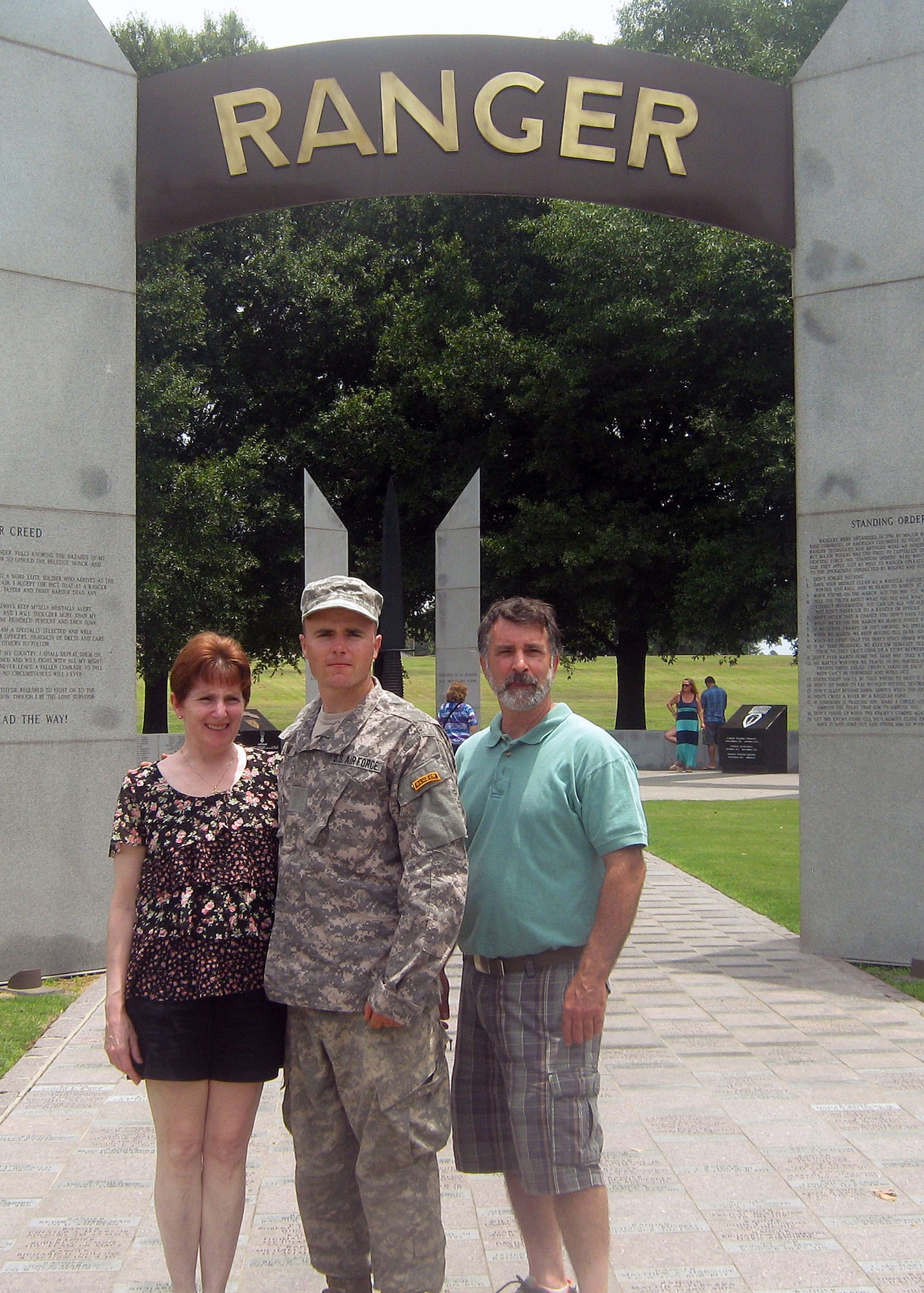 Senior Airman Brian Musum, 14th Air Support Operations Squadron tactical air control party member, stands with his parents, Margaret and Matthew Musum, after his graduation ceremony from Army Ranger School. (Courtesy photo)