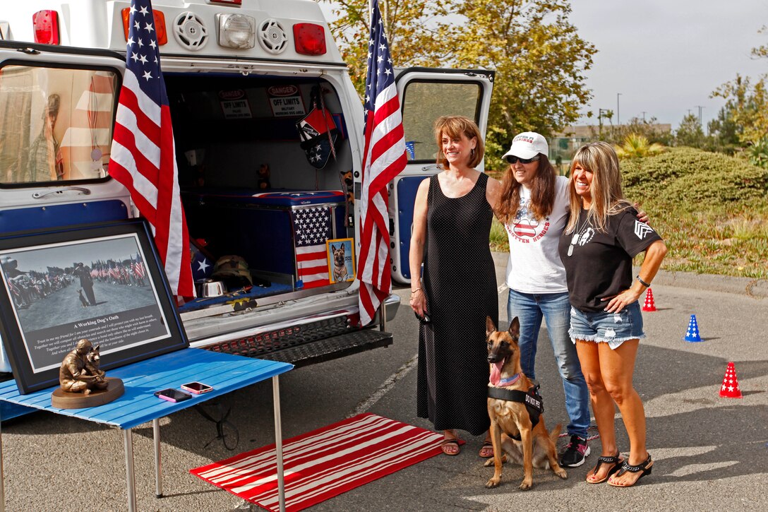 Two 'gold star' mothers, Julie Schrock (left) and Tammie Ashley (right), whose sons paid the ultimate sacrifice for their country, attend a memorial in honor of military working dog handlers at the Pacific Views Event Center's Memorial Garden here, Aug. 9.  The Dawgs Project, a company dedicated to military working dog handlers of all services, unveiled the memorial to commemorate K-9 handling service members. 