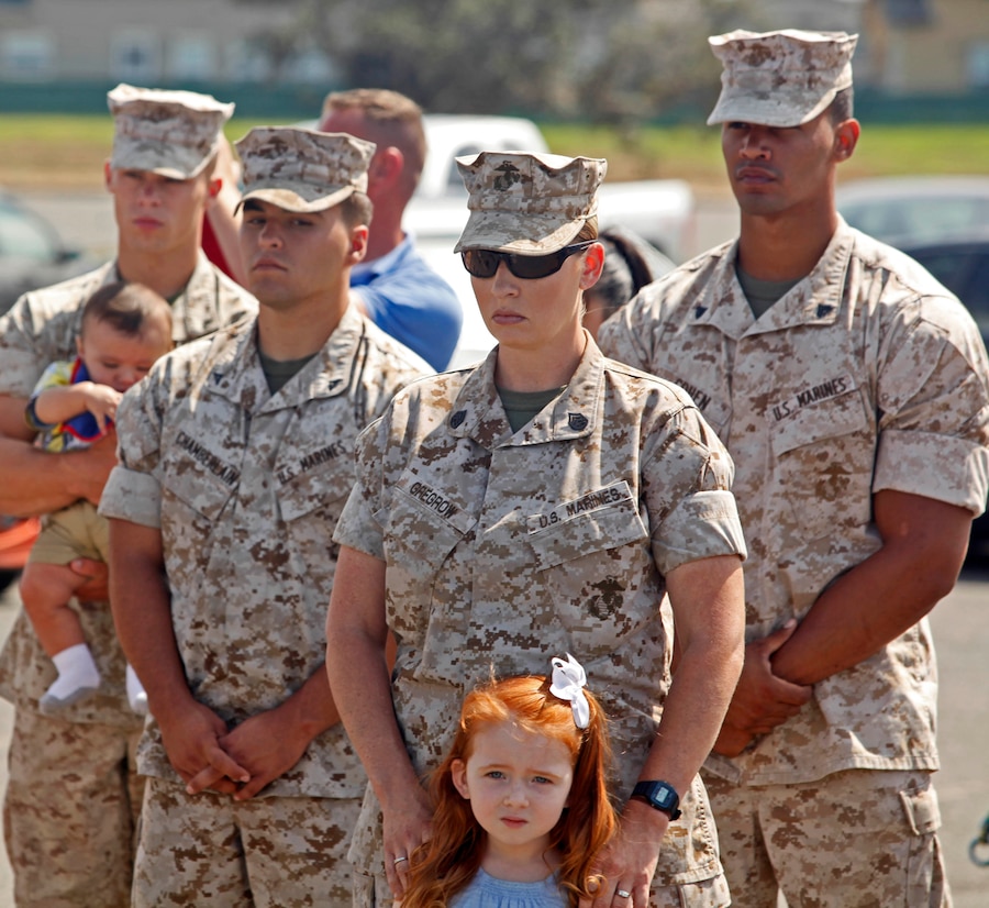 Military dog handlers with the United States Marine Corps and their families attend a memorial dedicated to their fallen comrades at the Pacific Views Event Center's Memorial Garden here, Aug. 9.  The Dawgs Project, a company dedicated to military working dog handlers of all services, unveiled the memorial to commemorate K-9 handling service members.