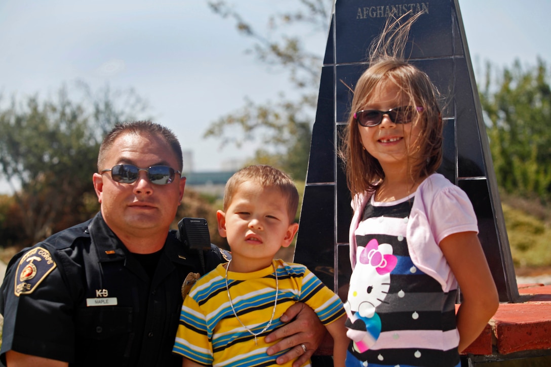 2nd Lt. Benjamin Maple, the kennel master with the Marine Corps Police Department Camp Pendleton K-9 Unit, attends a memorial dedication with his children, Ajay Maple, 2(center) and Taylor Star Maple, 6 (right) at the Pacific Views Event Center’s Memorial Garden here, Aug. 9.  The Dawgs Project, a company dedicated to military working dog handlers of all services, unveiled the memorial to commemorate K-9 handling service members.