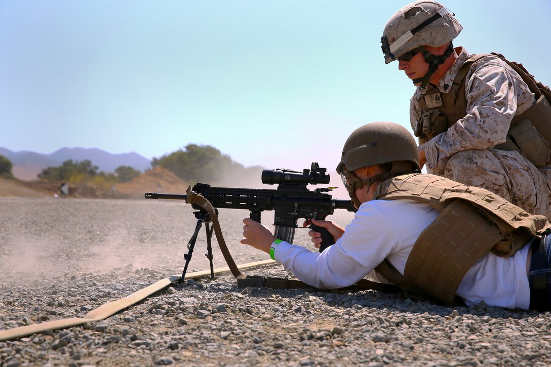 Maureen Nightwine fires the M27 Infantry Automatic Rifle during the Jane Wayne Day event at the School of Infantry here, Aug. 9.

The day started off with one group breaking off to learn how to operate different weapons systems such as the M16 service rifle and the M9 service pistols using the Indoor Simulated Marksmanship Trainer. They travelled to Range 210C to conduct a live-fire shoot with the M27 Infantry Automatic Rifle.

"It was a fun experience," said Kaylee Walter, whose husband serves as the executive officer for India Company, Marine Combat Training Battalion, SOI-W. "It was surprising how heavy the weapon was and how hard it was to hit the target. It really gave me a whole new understanding and appreciation as to what my husband does."
